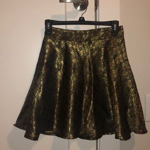 Cute “A” shaped, gold and black miniskirt